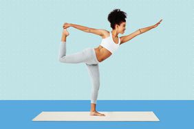 A woman balancing on one foot while doing yoga on a designed background