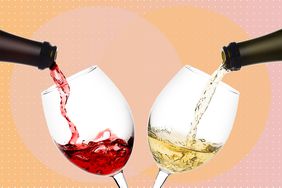 wine being poured into two glasses