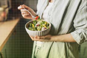 a photo of someone eating a bowl of salad