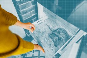 Woman reaching into a full freezer