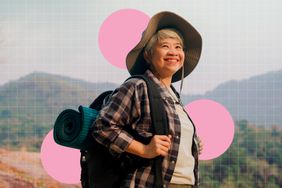 a photo of a woman hiking up a hill