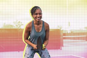 a woman playing tennis outside