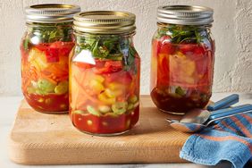 Side view photo of 3 jars of Anti-Inflammatory Eat-the-Rainbow soup after broth is added with lid on top.