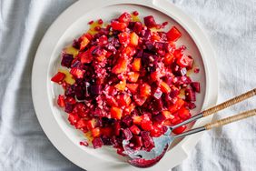 overhead shot of colorful cubed beet salad on a white plate