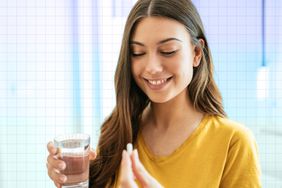 a photo of a woman taking a supplement with a glass of water