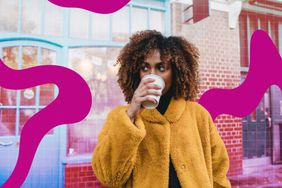 a photo of a woman sipping on a cup of coffee while standing outside on the street