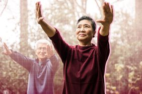 a photo of a Senior couple doing Tai Chi outdoors 