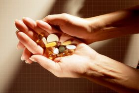 a photo of hands holding multiple kinds of supplements
