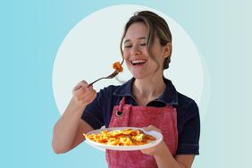 a photo of Carleigh Bodrug holding a plate of pasta and having a bite