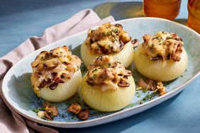 Angle view of a serving plate of Cheesy Vegetarian Stuffed Onions recipe