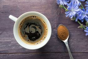 chicory coffee in a white mug on wooden background
