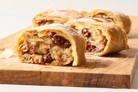 a photo of the Apfelstrudel sliced on a wooden cutting board