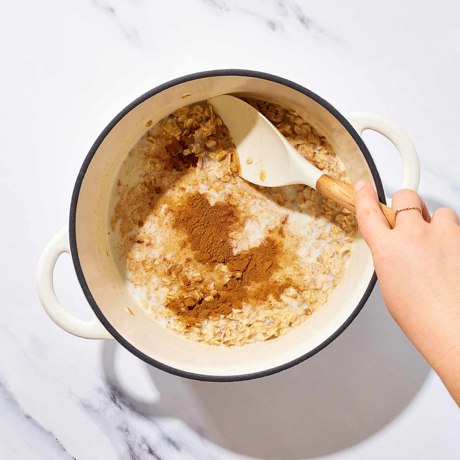 an image of the cinnamon being stirred into the oats