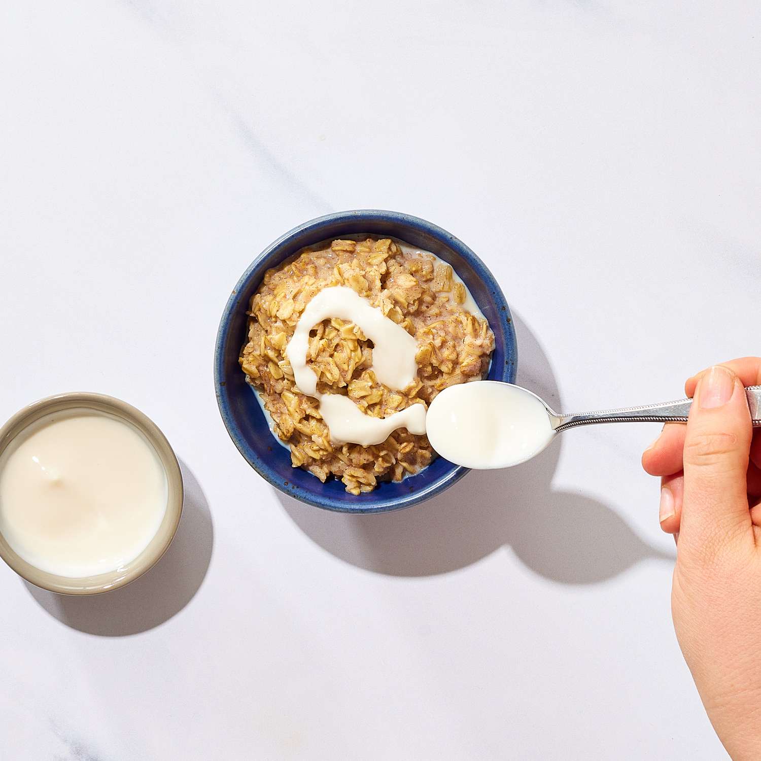 an image of the oats being drizzled with the yogurt mixture