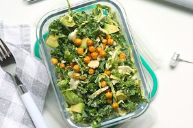 container of healthy looking salad on a desk