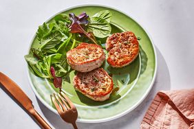 Pan-seared Pork Tenderloin Medallions with a simple side salad of greens on the plate