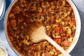 American Goulash in a pot with a wooden spoon