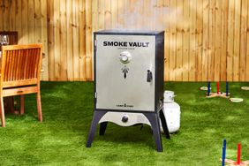 The Smoke Vault smoker in a fenced backyard.