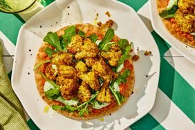 a recipe photo of the Spiced Cauliflower Bites with Whipped Ricotta & Muhammara and Greens with Pita