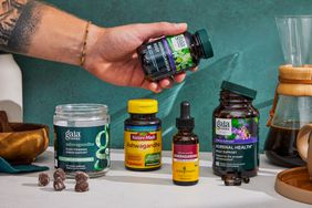 A person holding a bottle of Ashwagandha supplements, along with a selection of other supplements we tested