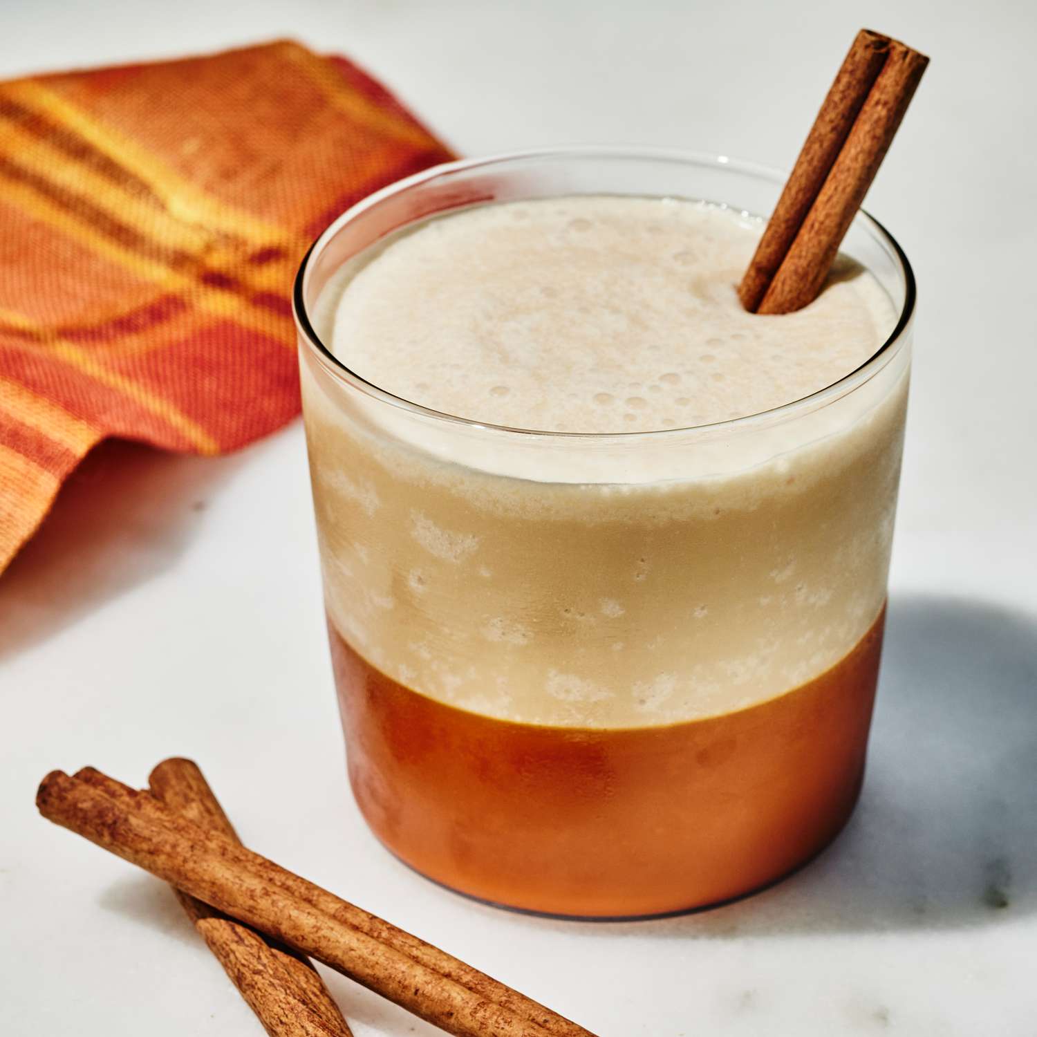 an image of the Whipped Frozen Apple Cider served with a cinnamon stick