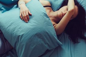 woman laying in bed looking exhaustedd