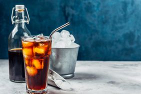 a photo of cold brew poured into a glass with ice