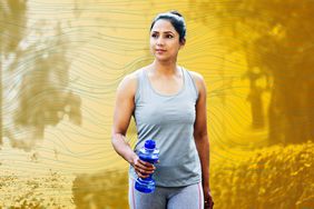 woman with dumbbell shape water bottle at park