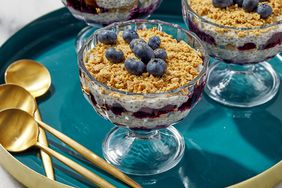 Angled view of Lemon-Blueberry Cheesecake Chia Pudding recipe in clear glass serving bowls