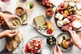a photo of a group of people eating Mediterranean food at a table