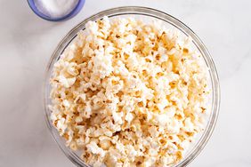 A bowl of popcorn on a marble surface