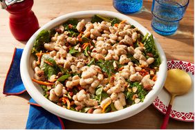 white bean salad with spinach, carrots, almonds in a serving bowl