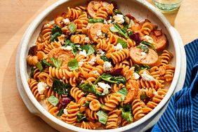 A white plate with a serving of the one-pot spinach, chicken sausage & feta pasta recipe