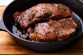 Closeup view of cooked Pan-Seared Strip Steaks in a black cast-iron skillet