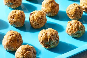 Peanut butter energy balls spread out on a blue tray
