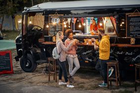 a photo of people grabbing food at a food truck