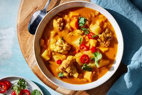 Overhead view of a bowl of Roasted Cauliflower & Potato Curry Soup recipe