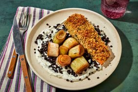 a photo of the Sheet Pan Crusted Salmon with Sliced Leeks served on a ceramic plate