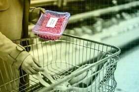 person holding package of meat over grocery cart
