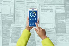 a hand holding a phone with a health app open on it and nutrition labels in the background