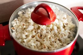 popcorn in a pan with glass lid