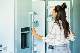 a photo of a woman looking into the refrigerator 