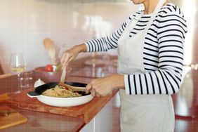 a photo of a person cooking pasta