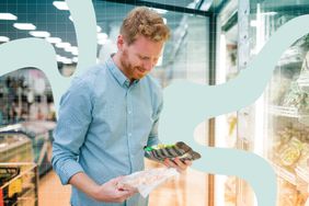a photo of a man looking at frozen food items in the grocery store