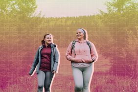 a photo of a couple friends walking outside in nature