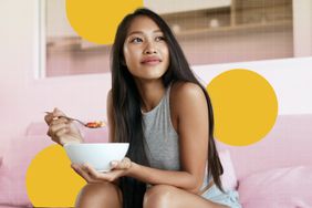 a photo of a woman enjoying a bowl of oatmeal while sitting on the couch