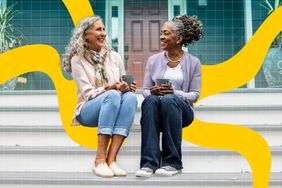 a photo of two friends sharing a coffee together while sitting on a front porch 