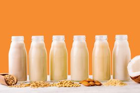 A bottles of alternative milk on an orange background
