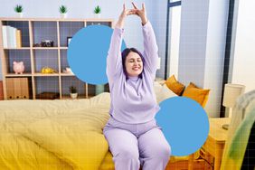 a photo of a woman stretching her arms while sitting on the bed after waking up