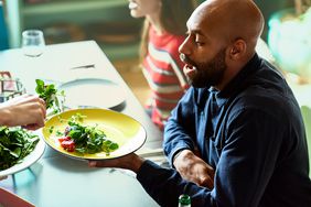 Man being served salad